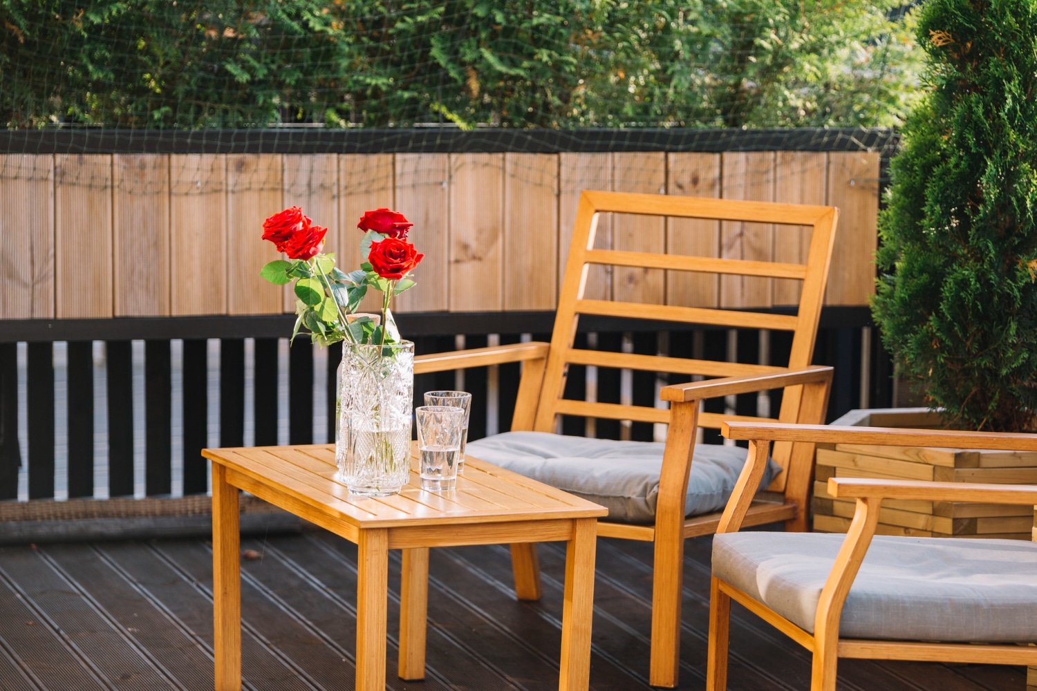 Wooden patio furniture with roses.