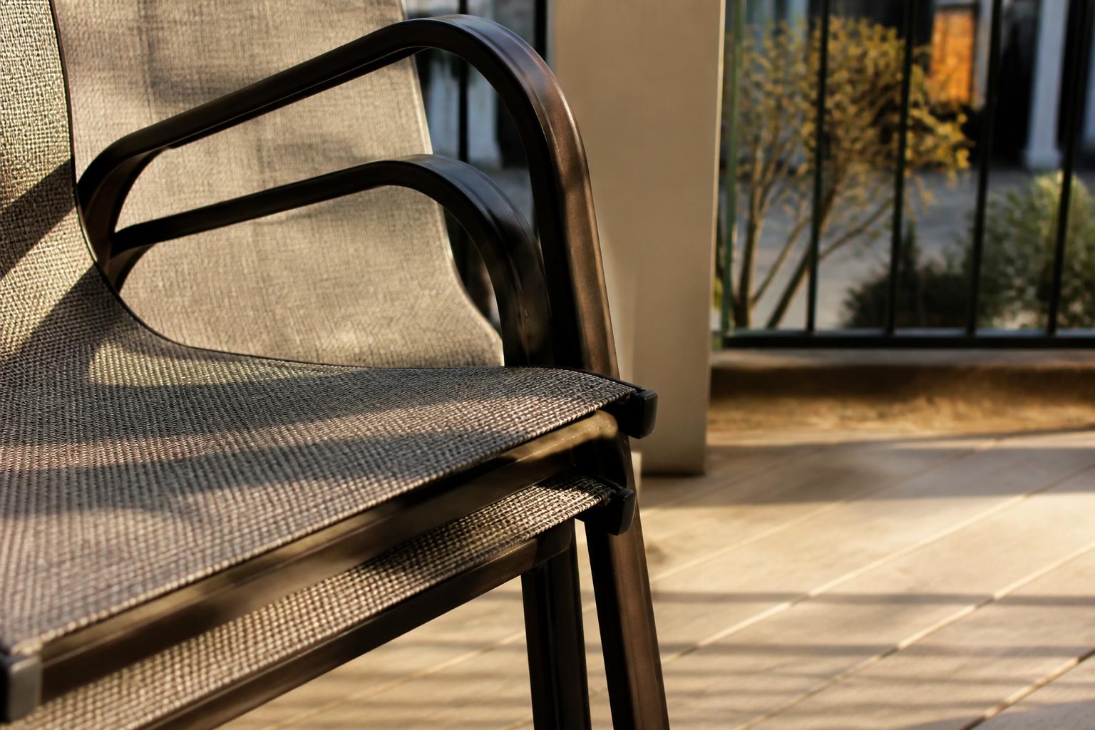Close-up of a stackable patio chair frame and seat material