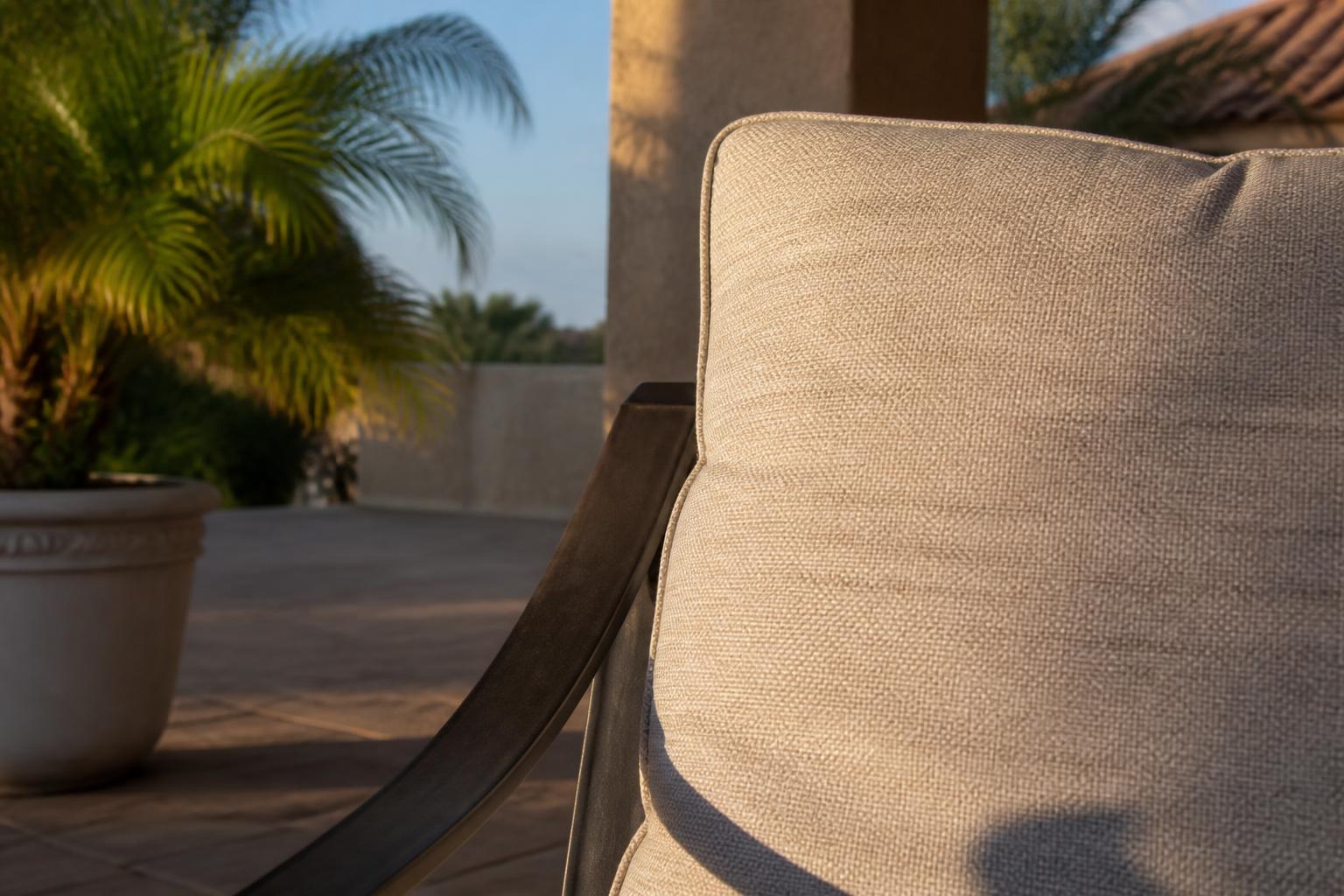 Close-up of a neutral-toned outdoor cushion fabric and frame color