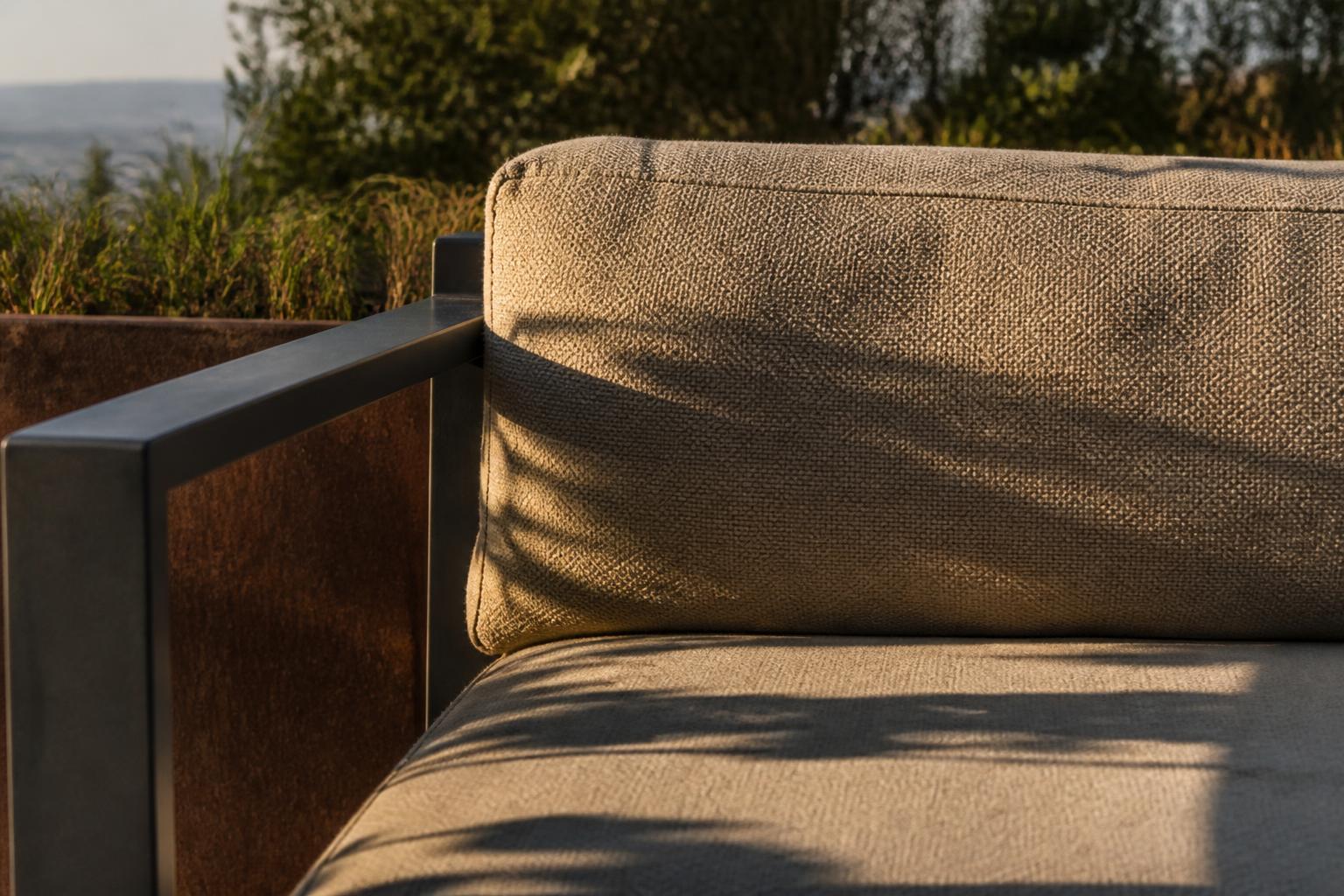 Close-up of an outdoor loveseat cushion fabric weave and armrest