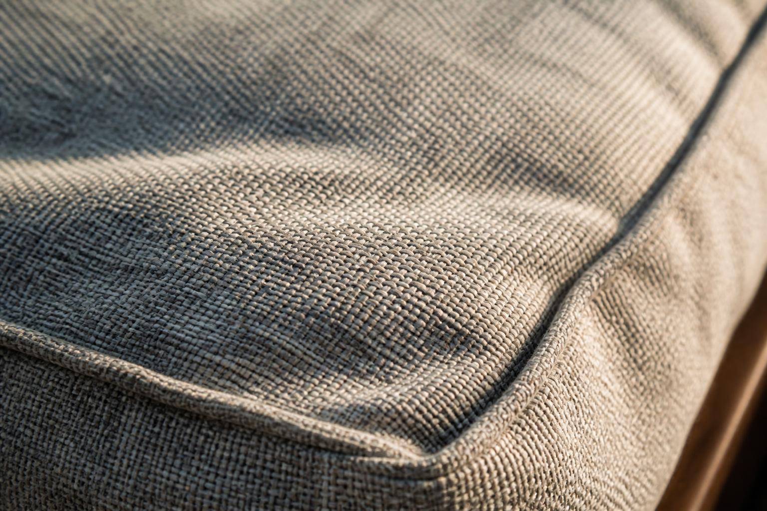 Close-up of woven outdoor cushion fabric showing a tight acrylic weave