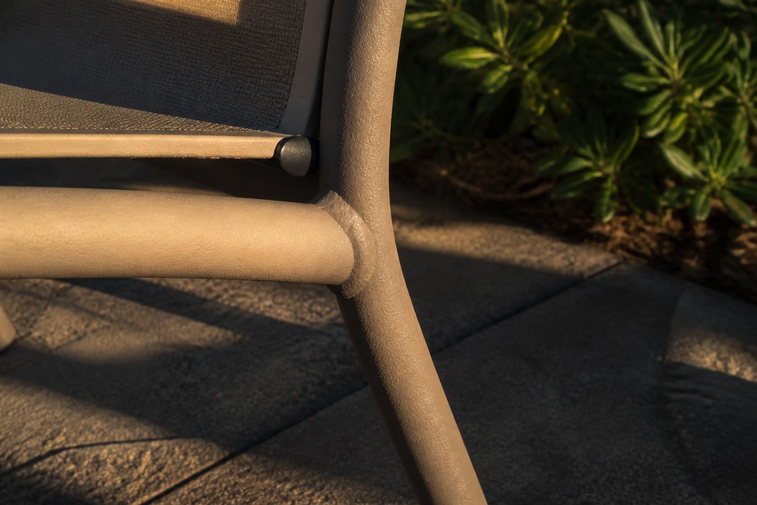 Close-up of an aluminum chair frame with textured powder-coat finish