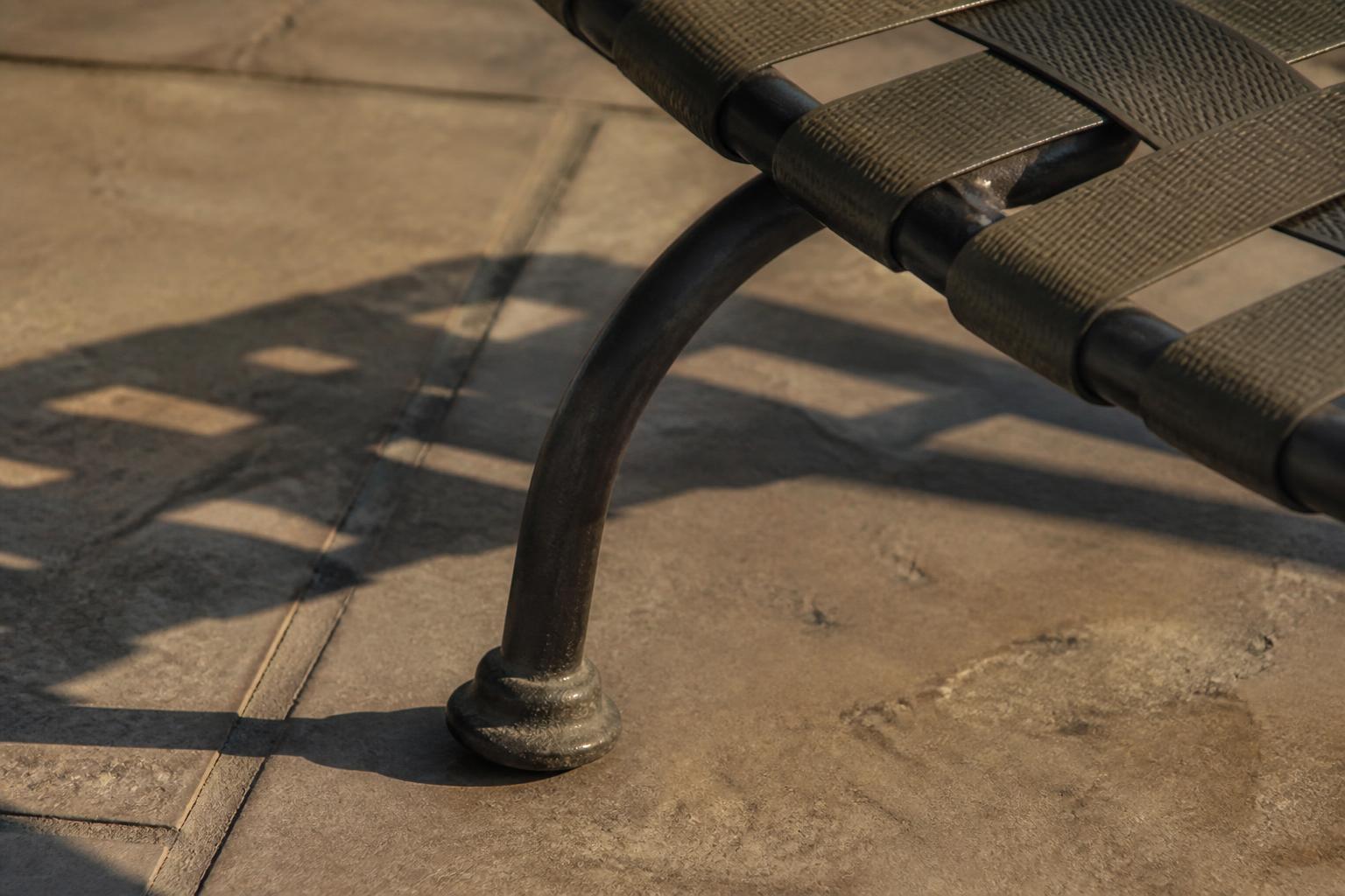 Close-up of a pool deck lounge chair strap material and non-slip foot base