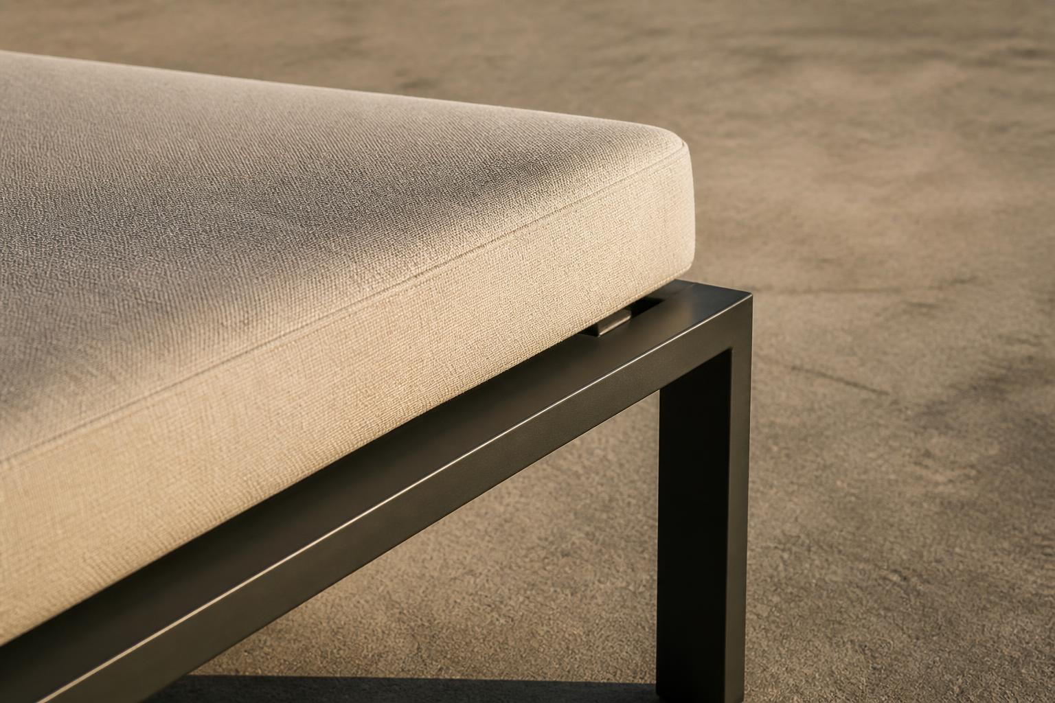 Close-up of an outdoor daybed's cushion and aluminum frame corner