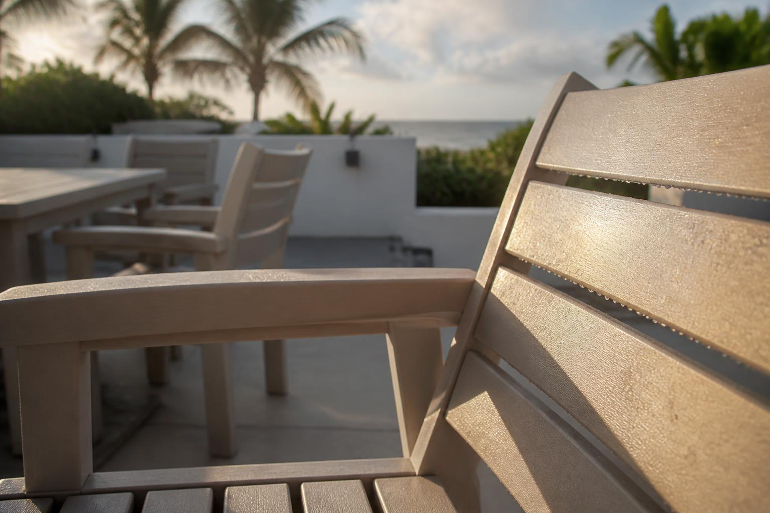 Raindrops on the slatted seat of a poly lumber patio chair