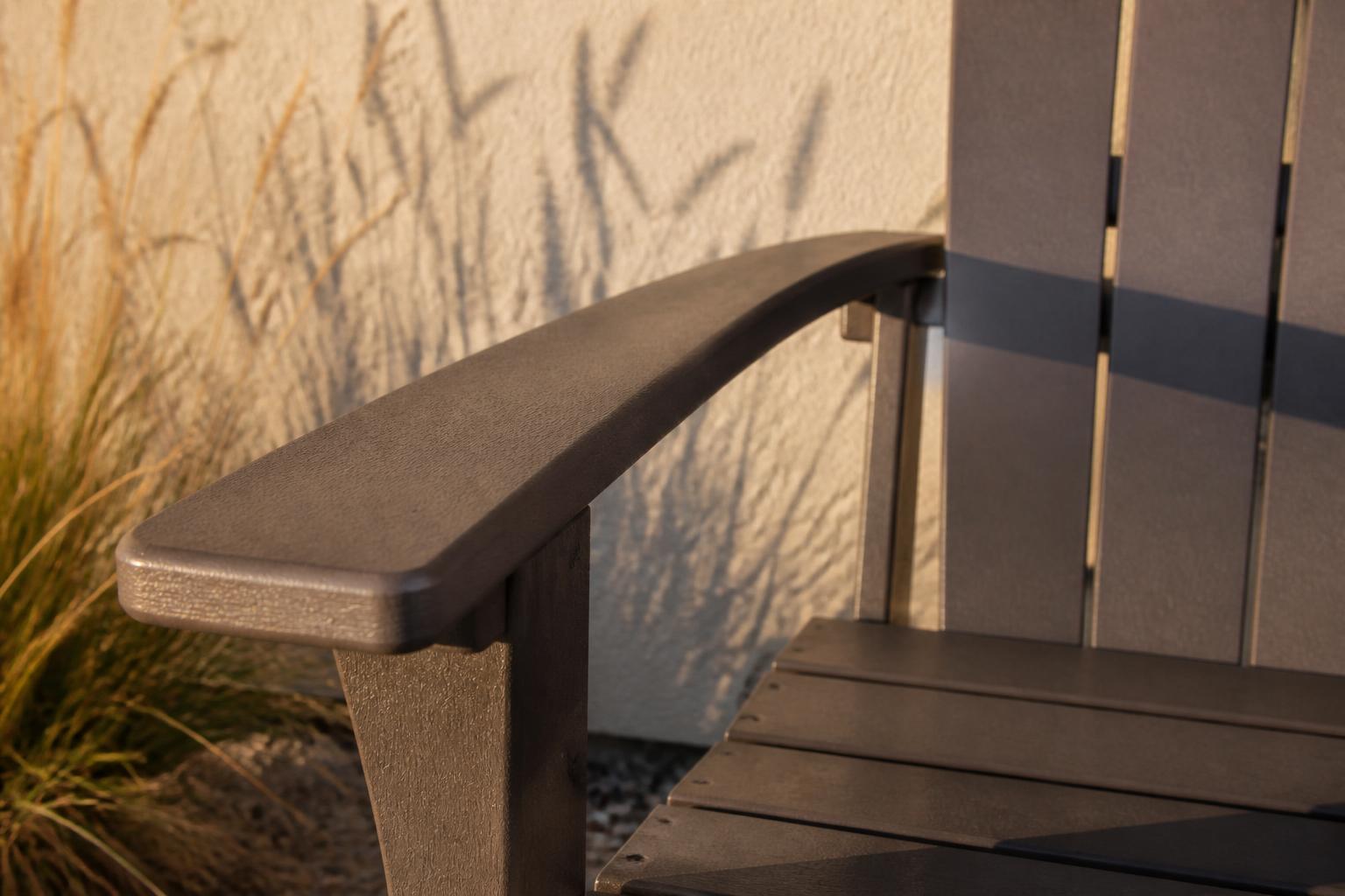 Close-up of a poly lumber Adirondack chair's wide armrest