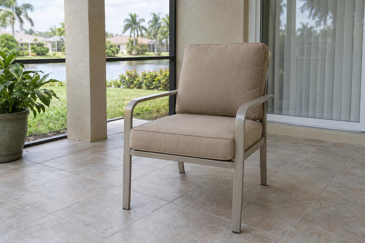 Outdoor chair with fitted tan seat and back cushions