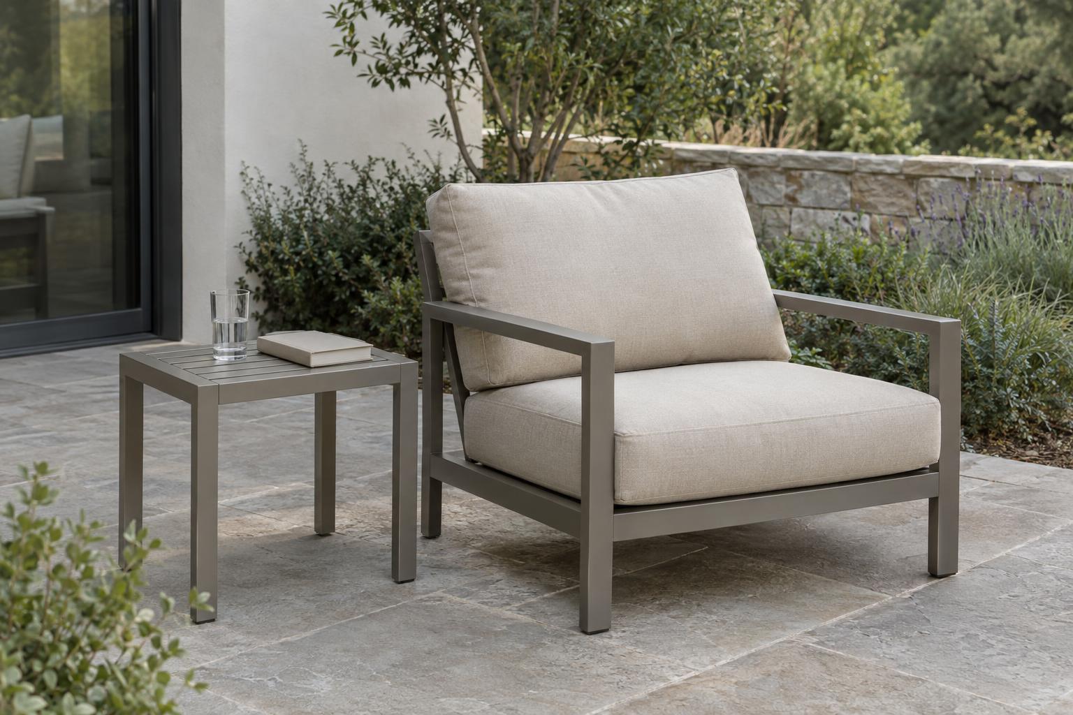 Outdoor lounge chair and side table with a book and drinking glass