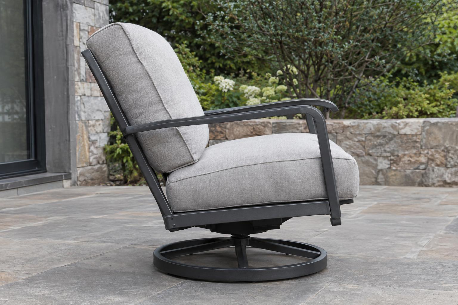 Side view of an outdoor swivel rocker chair and its circular base on level tile